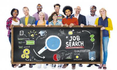 A group of recruitment consultants holding up a job search banner